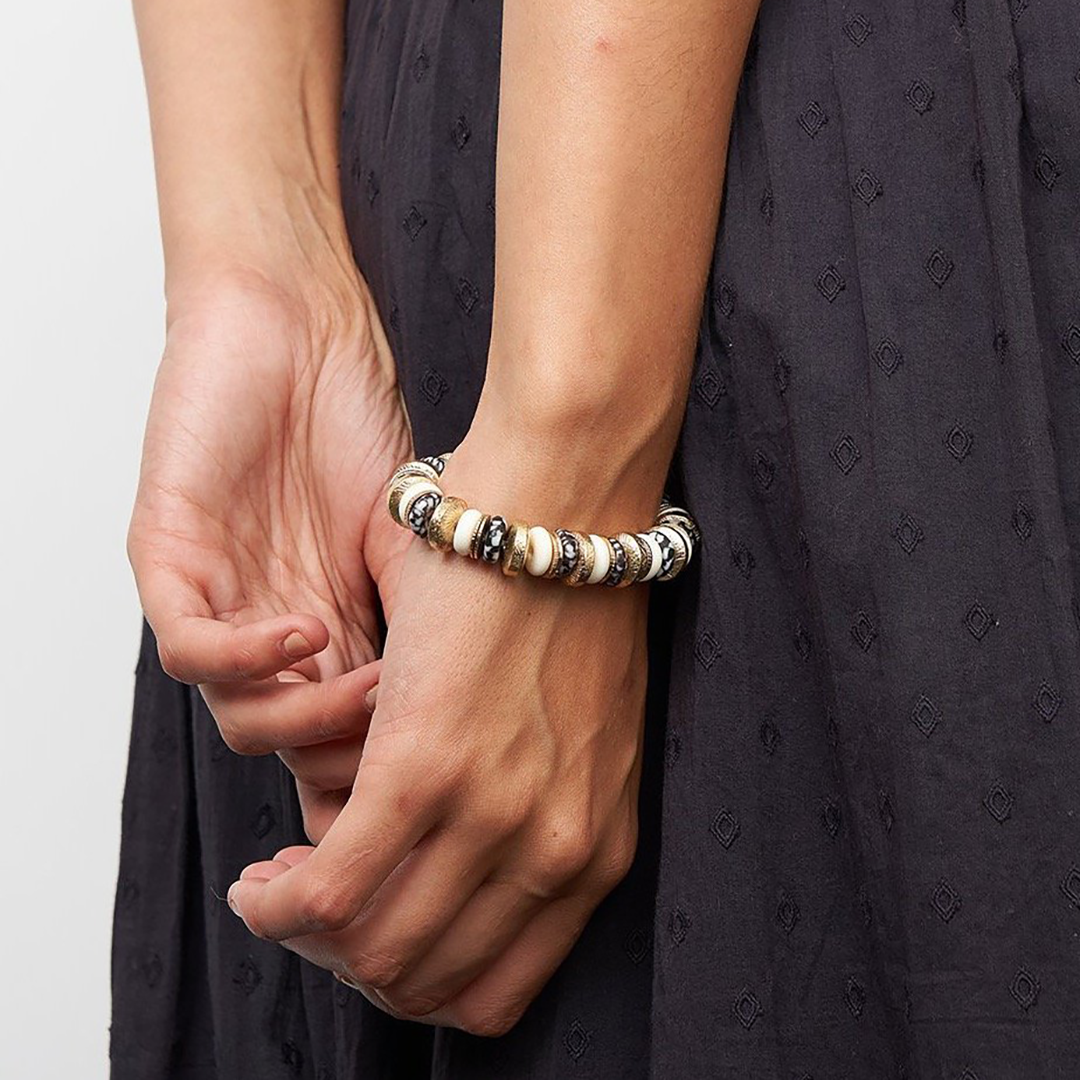 Close another woman's hands wearing hand crafted bracelets